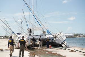 Agents from Coast Guard Investigative Service inspect aground sailboats and debris Sept. 15, 2017 at the Trumbo Point Annex for Naval Air Station Key West