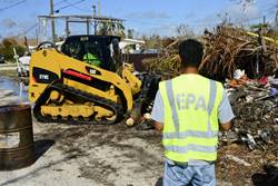 Subash Patel, an on-scene coordinator with the Environmental Protection Agency, directs the removal of barrels and containers displaced by Hurricane Irma in Big Pine Key, Florida, Oct. 3, 2017. EPA field teams, led by on-scene coordinators, are facilitating land-based assessments and response actions in coordination with the Unified Command of Emergency Support Function 10 Florida. U.S. Coast Guard photo by Petty Officer 2nd Class David Weydert.