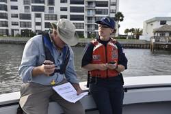Coast Guard Petty Officer 3rd Class Erin O'Shea and Randy Runnels, Preserves Manager for Florida Department of Environmental Protection, work together to pinpoint the exact GPS location and identification for a sunken vessel, near Ward Island, Florida, Pinellas County, October 7, 2017. The Coast Guard is overseeing the removal of vessels displaced by Hurricane Irma throughout Florida. U.S. Coast Guard photo by Petty Officer 1st Class Sara Romero.
