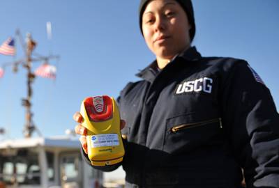 BALTIMORE - Seaman Ashleigh Wilson, a boatcrew member at Aids to Navigation Team Baltimore, holds a personal emergency position indicating radio beacon on a pier located in Curtis Bay, Md., Dec. 9, 2010. Crewmembers at ANT Baltimore carry PEPIRBs while servicing aids throughout the upper Chesapeake Bay. U.S. Coast Guard photo by Petty Officer 3rd Class Robert Brazzell.